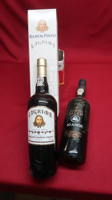 two bottles of liquor sitting on a red table next to a bottle of liquor