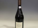 the bottle of red wine is sitting on the table
