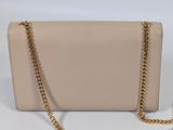 a white purse with gold chain on a white background