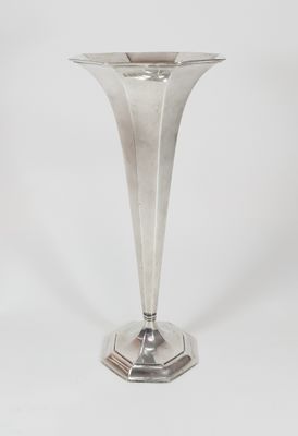 silver plated vase on pedestal on white background with white background
