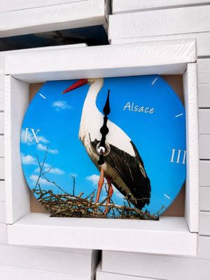 a clock with a picture of a stork on it