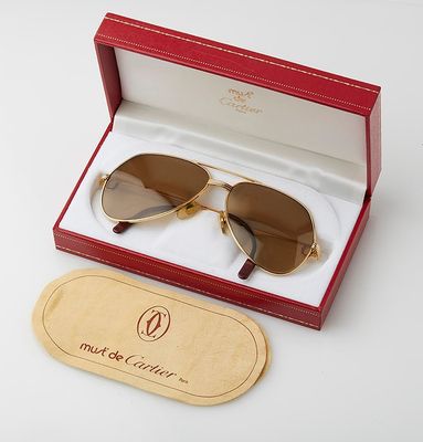 a box with a pair of sunglasses in it on a white surface