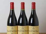 three bottles of wine sitting on top of a wooden table