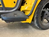 a close up of the front bumper of a yellow vehicle