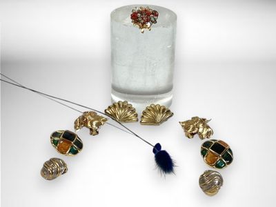 a glass of water and some jewelry on a table