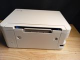 a white printer sitting on top of a wooden table