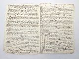 an old book with writing on it sitting on top of a table