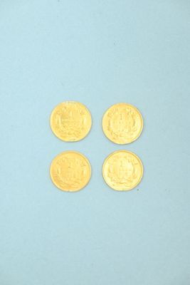 four gold coins are arranged in a row on a blue surface