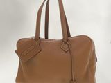 a close up of a brown handbag on a white background