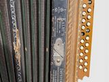 an old black and white photo of an accordion on a white background
