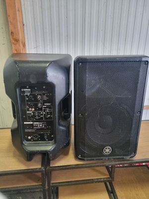 two speakers sitting on top of a table next to each other
