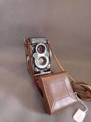 a brown leather case with a camera attached to it