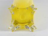 an image of a yellow candle holder with a face on it