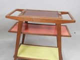 an image of a wooden serving cart with two trays on it