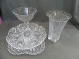 two glass vases and a plate on a table