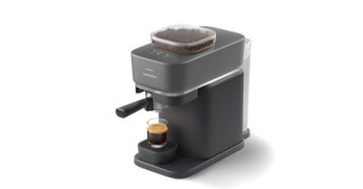 une image représentant une machine à café sur laquelle est posée une tasse de café