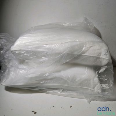 a bag of white pillows sitting on a table