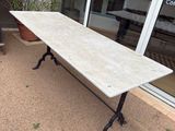 a long table with a marble top on a patio