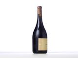 a bottle of wine sitting on top of a white table