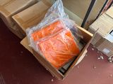 a box of carrots sitting on the floor next to a pile of boxes