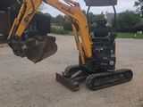 a small excavator that is parked in the dirt