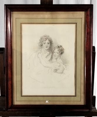 dessin représentant une mère et son enfant, encadré et posé sur une table