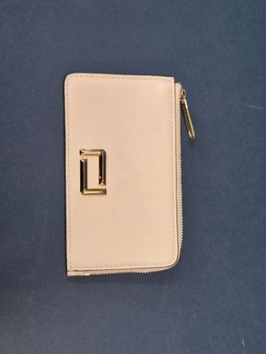 a small white wallet with a gold buckle on it