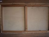 a window in the corner of a room with a wooden frame