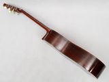 a close up of a guitar on a white surface