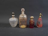 three different colored glass bottles sitting next to each other on a table
