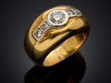 a yellow gold ring with a diamond set in the center