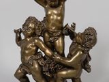une image représentant une statue en bronze de trois enfants jouant avec un ballon