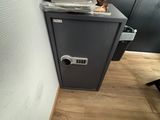 a stack of papers sitting on top of a filing cabinet