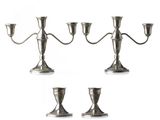three silver metal candlesticks on a white background with a white background