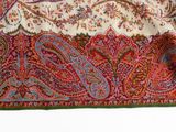 a close up of a paisley print scarf on a table