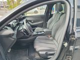 the interior of a car with the door open and the driver ' s seat down