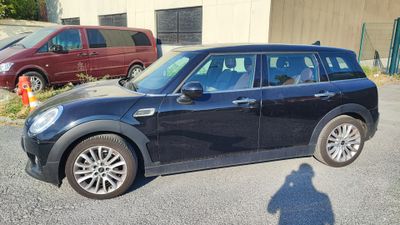 a small black car parked in a parking lot