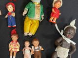 a lot of dolls that are sitting on a table