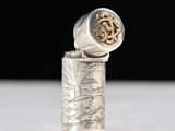 an antique silver cigarette case with a design on it