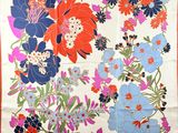 an image of a colorful floral print scarf hanging on a wall