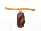 wooden sculpture of a cat with a long neck on a white surface