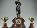 a statue of a woman standing on a pedestal next to three trophies