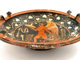 a black and orange bowl with an image of a man on a horse