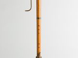 an old wooden recorder with a metal handle on a white background