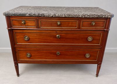 a marble top chest of drawers on display in a room