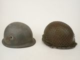 two helmets with netting on them sitting next to each other