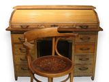 a wooden desk with a wooden chair next to it