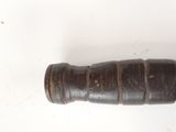 a small wooden object that is on a white surface