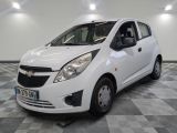 a picture of a small white car parked on a checkered floor