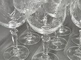 six empty wine glasses sitting on top of a table next to each other